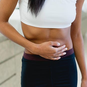 Woman experiencing a cramp
