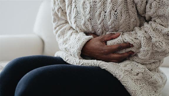 Woman experiencing a stomach cramp