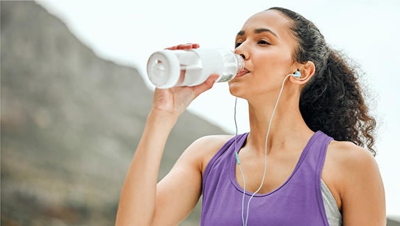 Woman drinking water during her workout