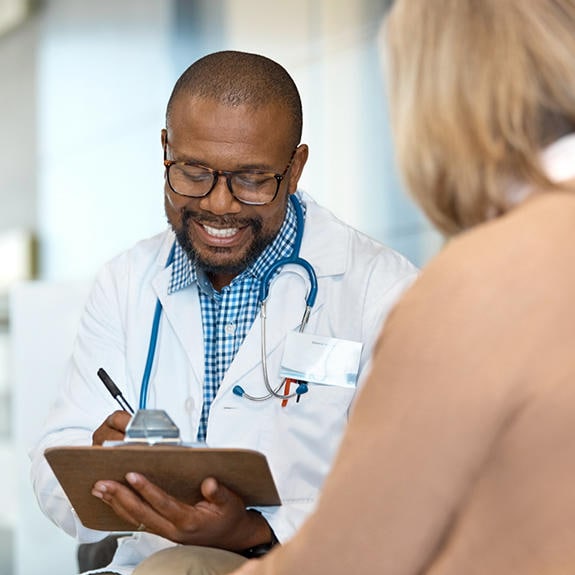 Doctor taking notes during appointment